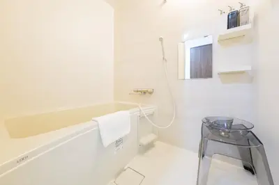 a white bathroom with a sink and a towel at \u5317\u5c0f\u5ca9\u6238\u5efa in Tokyo