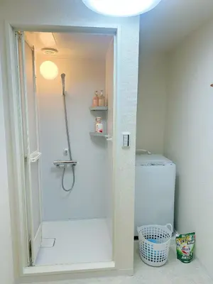 a bathroom with a shower and a toilet in a room at Ueno Sakura Inn \u4e0a\u91ce\u516c\u56ed in Tokyo