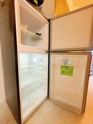 an empty refrigerator with its door open in a kitchen at Ueno Sakura Inn \u4e0a\u91ce\u516c\u56ed in Tokyo