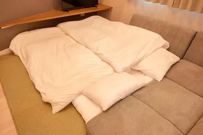a pile of pillows sitting on top of a couch at Hotel ITSUKI in Tokyo