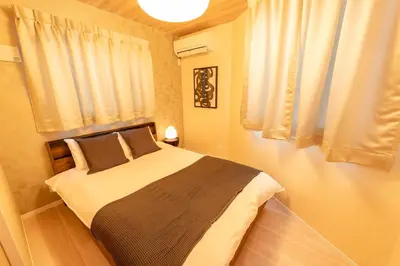 a bedroom with a large bed in front of a window at Hotel ITSUKI in Tokyo