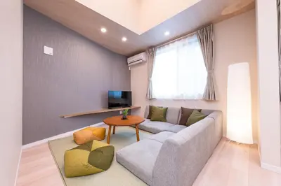 a living room with a couch and a table at Hotel ITSUKI in Tokyo