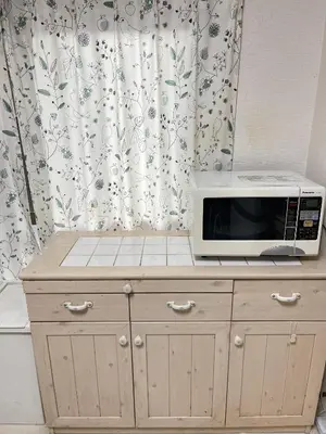 a microwave oven sitting on top of a cabinet at \u671b\u6708\u30cf\u30a6\u30b9201 in Tokyo