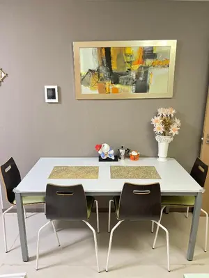 a dining room table with chairs and a vase of flowers at \u671b\u6708\u30cf\u30a6\u30b9201 in Tokyo