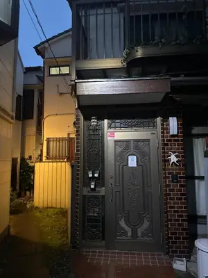 an entrance to a building with a black door at \u671b\u6708\u30cf\u30a6\u30b9201 in Tokyo
