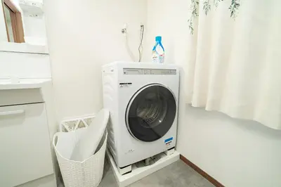 a washer and dryer in a white laundry room at 1, Horikiri Entire house for rent, \u5800\u5207 in Tokyo
