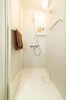 a white bathroom with a shower and a sink at 1, Horikiri Entire house for rent, \u5800\u5207 in Tokyo