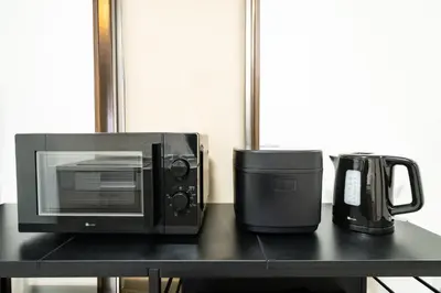 a microwave and a coffee maker on a table at 1, Horikiri Entire house for rent, \u5800\u5207 in Tokyo