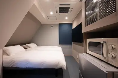 a small bedroom with a bed and a tv at EISEI STAY Ikebukuro Nishi in Tokyo