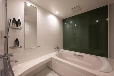 a white bathroom with a tub and a sink at EISEI STAY Ikebukuro Nishi in Tokyo