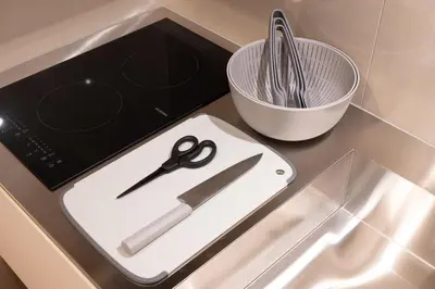 a pair of scissors on a cutting board on a counter at EISEI STAY Ikebukuro Nishi in Tokyo