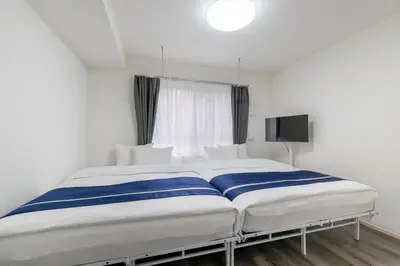 a large bed in a room with a window at ef\u6c60\u888b202 in Tokyo