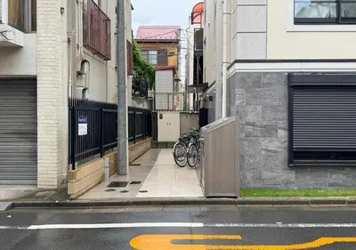 a group of bikes parked on a sidewalk next to a street at ef\u6c60\u888b202 in Tokyo