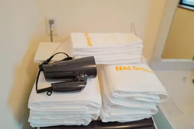 a pile of towels and a hair dryer on a table at Akira Hiro House - Room102 in Tokyo