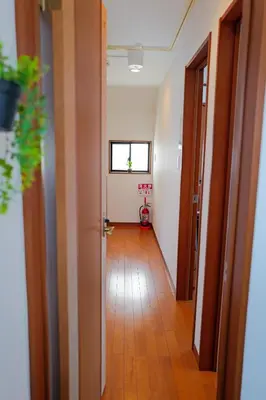 a hallway of an apartment with a room with a window at Akira Hiro House - Room102 in Tokyo