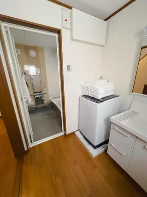 a room with a bathroom with a sink and a refrigerator at Akira Hiro House - Room103 in Tokyo