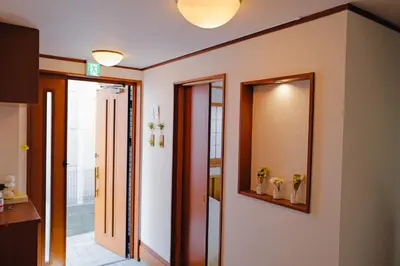 a bathroom with a mirror and a hallway at Akira Hiro House - Room103 in Tokyo