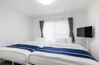 a large bed in a room with a tv at ef\u6c60\u888b301 in Tokyo