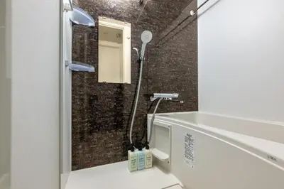 a bathroom with a shower with a sink and a mirror at ef\u6c60\u888b301 in Tokyo