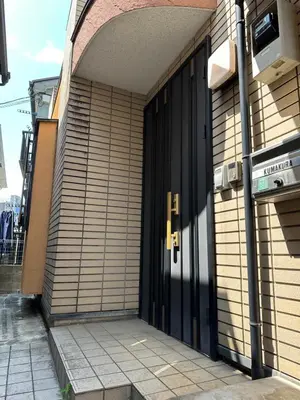 an entrance to a building with a black door at Akira Hiro House - Room201 in Tokyo