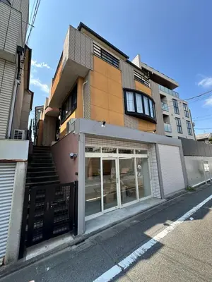 a building with a store with glass doors on a street at Akira Hiro House - Room201 in Tokyo