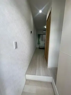 a hallway with white walls and a wooden floor at \u6843\u6843\u5b50\u306e\u30cf\u30a6\u30b9101 in Tokyo
