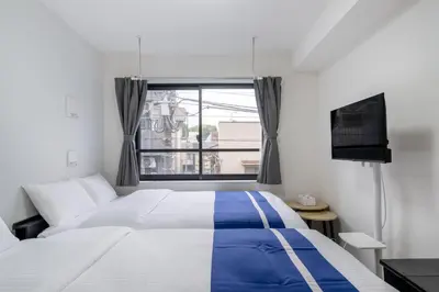 a bedroom with a bed and a tv and a window at ef\u6c60\u888b303 in Tokyo