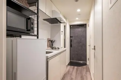 a small kitchen with a refrigerator and a sink at ef\u6c60\u888b303 in Tokyo