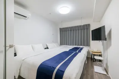 a bedroom with a large bed and a television at ef\u6c60\u888b303 in Tokyo