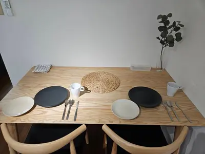 a wooden table with plates and utensils on it at \u30db\u30c6\u30eb\u30ec\u30b9\u30dd\u30ef\u30fc\u30eb305 in Tokyo