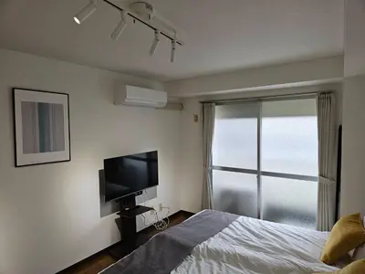 a bedroom with a bed and a flat screen tv at \u30db\u30c6\u30eb\u30ec\u30b9\u30dd\u30ef\u30fc\u30eb305 in Tokyo