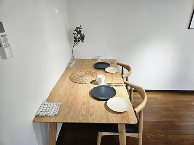 a wooden table with bowls and plates on it at \u30db\u30c6\u30eb\u30ec\u30b9\u30dd\u30ef\u30fc\u30eb305 in Tokyo