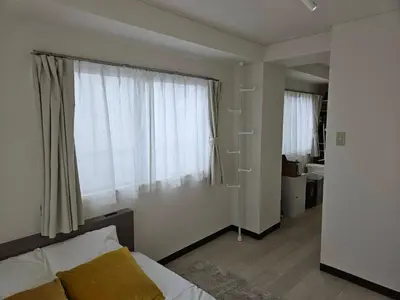a bedroom with a bed and a large window at \u30db\u30c6\u30eb\u30ec\u30b9\u30dd\u30ef\u30fc\u30eb405 in Tokyo