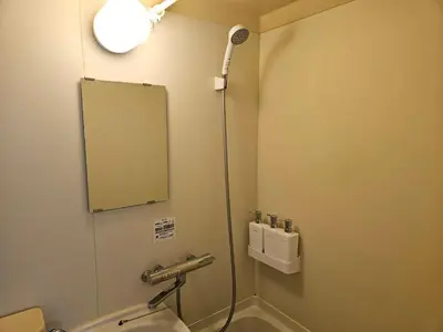 a bathroom with a mirror and a sink and a shower at \u30db\u30c6\u30eb\u30ec\u30b9\u30dd\u30ef\u30fc\u30eb405 in Tokyo