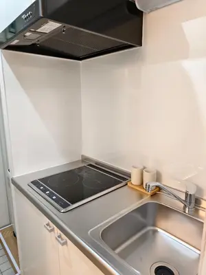 a kitchen with a sink and a stove at THE ONE kouennji in Tokyo