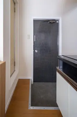 a bathroom with a shower with a glass door at House Hotel Shinnakano 202 in Tokyo