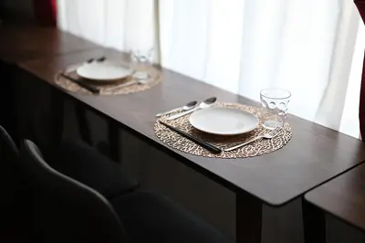 a table with plates and glasses on top of it at OMORI Red&Blue Hotel in Tokyo