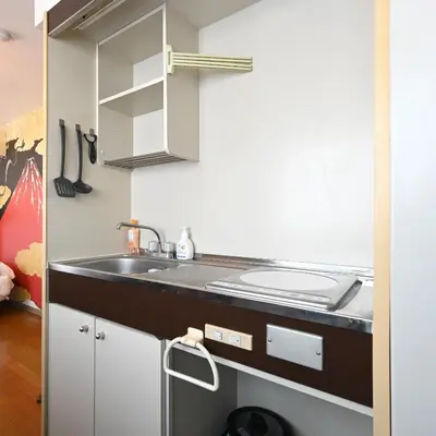 a kitchen with a sink and a counter at OMORI Red&Blue Hotel in Tokyo