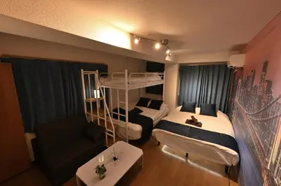 a bedroom with two beds and a bunk bed at OMORI Red&Blue Hotel in Tokyo
