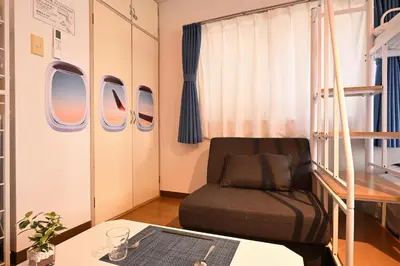 a small room with a chair and a table at OMORI Red&Blue Hotel in Tokyo