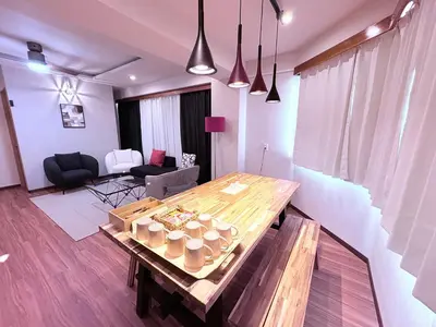 a living room with a wooden table with cups on it at Spacious Family Stay Shinagawa-Kokoro House 3 in Tokyo