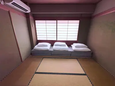 a room with two beds in front of a window at Spacious Family Stay Shinagawa-Kokoro House 3 in Tokyo