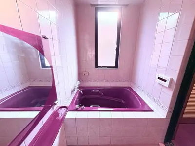 a pink bath tub in a bathroom with a mirror at Spacious Family Stay Shinagawa-Kokoro House 3 in Tokyo
