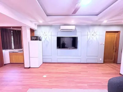 a living room with a tv on a wall at Spacious Family Stay Shinagawa-Kokoro House 3 in Tokyo