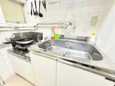 a kitchen with a sink and a stove at Shinjuku Waseda D1 in Tokyo
