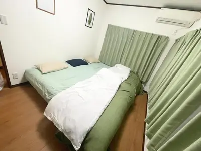 a small bedroom with two beds and a window at Amazing location Harajuku House Shibuya 8pepl 2BR in Tokyo