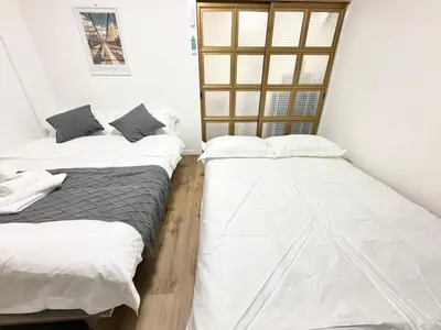 two beds sitting next to each other in a room at Shinjuku Waseda D2 in Tokyo