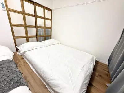 a bedroom with two beds and a window at Shinjuku Waseda D2 in Tokyo