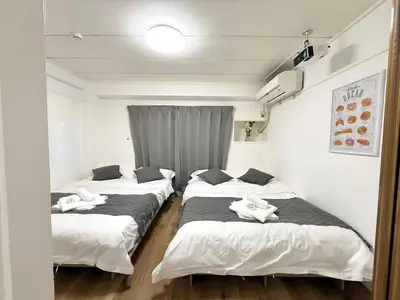 a group of three beds in a room at Shinjuku Waseda Cartref 3 in Tokyo