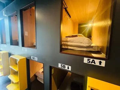 a room with two mirrors and a bed in it at Otemachi Kamon Hotel in Tokyo